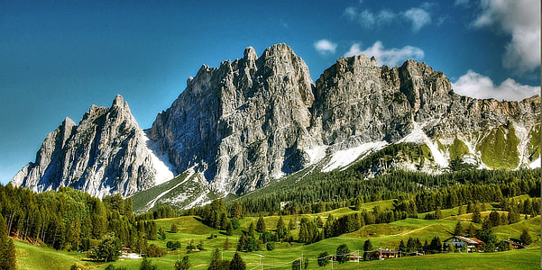 green fields and mountain during daytime thumbnail