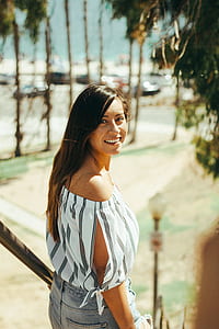 woman in white off-shoulder top taking a photo thumbnail
