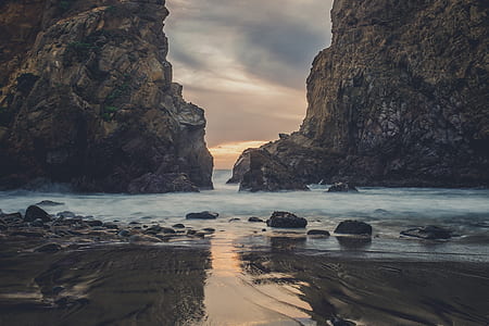 two brown rock formation on sea thumbnail