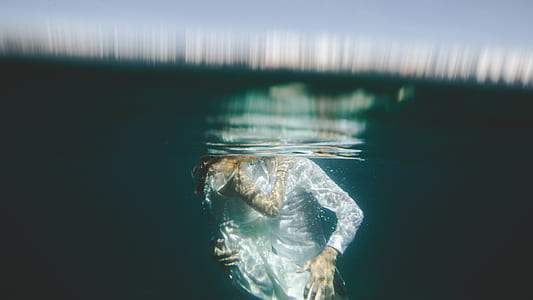 man and woman hugging in body of water thumbnail