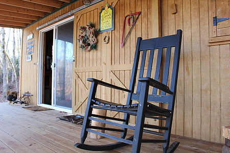black wooden rocking chair near glass door panel thumbnail