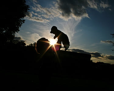 silhouette of woman carrying a dog thumbnail