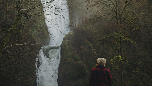 woman in red jacket facing waterfalls thumbnail