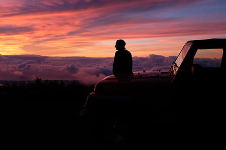person sitting on car hood thumbnail