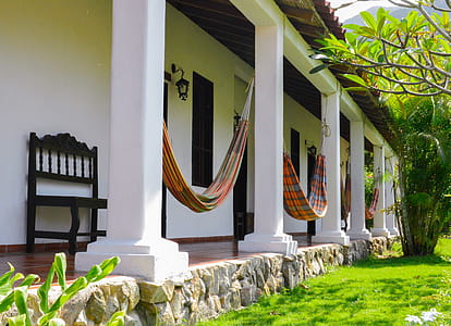 Several Orange Hammocks Hanged on White Concrete Posts thumbnail