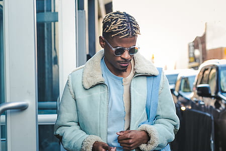 man walking on street wearing blue jacket thumbnail