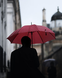 selective focus photography of man holding umbrella thumbnail