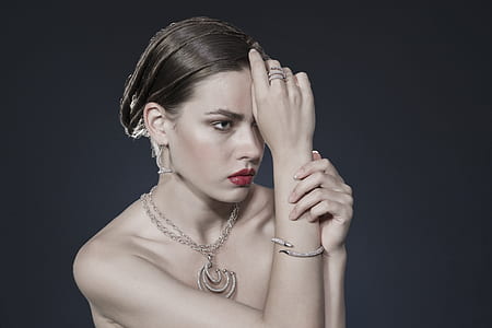 topless woman with silver-colored necklace and red lip tint thumbnail