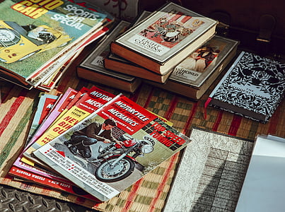 assorted-color book lot on brown surface thumbnail