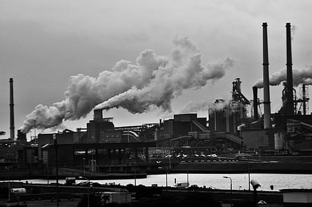 Grayscale Photography of Locomotive Train Beside Factory thumbnail