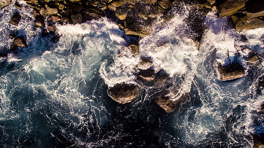 bird's eye view photo of waves near seashore during daytime thumbnail