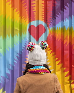Girl with gumball beanie admires heart mural thumbnail