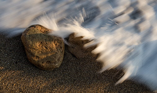timelapse photography of wave smashing stone thumbnail