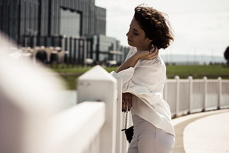 Woman Leaning on White Wooden Picket Fence thumbnail