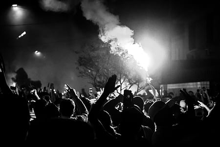 grayscale photography of person holding lighted flare thumbnail