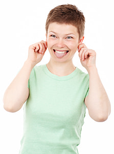 woman in teal crew-neck T-shirt making funny face gesture thumbnail
