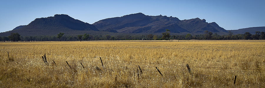 grass field near mountains during daytime thumbnail