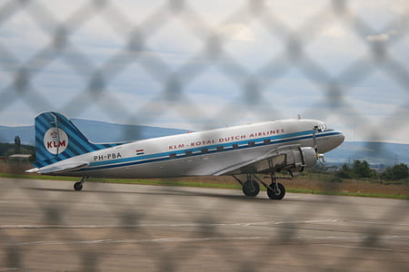 white and blue airplane on airport runway during daytime thumbnail