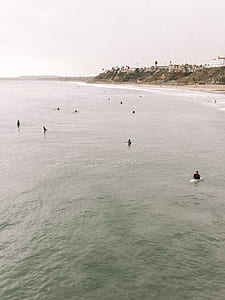 people swimming during daytime thumbnail