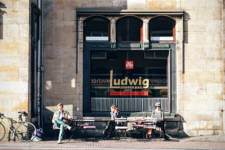 photo of three people sitting in front of Ludwig coffee thumbnail