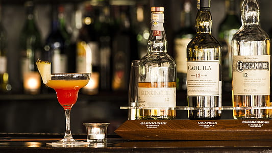 martini glass near liquor bottles thumbnail