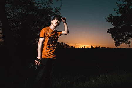 Close-up Photo of a Man Wearing Orange Shirt thumbnail