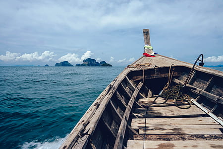 closeup photo of brown boat on body of water thumbnail
