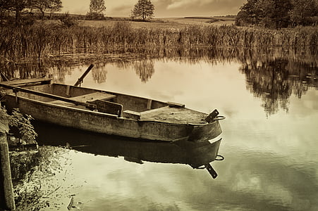gray jon boat near dock thumbnail