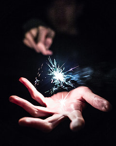 focus photography of person holding sparkler thumbnail