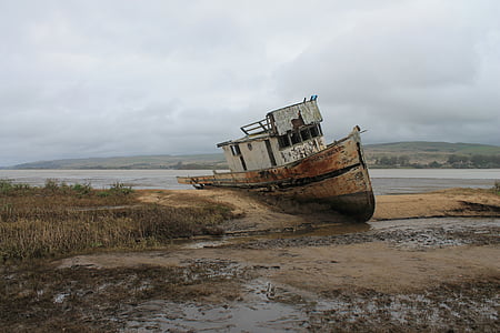 gray shipwreck beside sea thumbnail