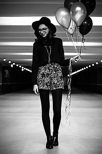 grayscale woman holding balloons thumbnail