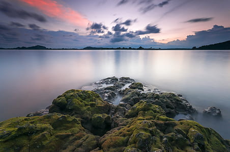Green Mountains in Front of Body of Water thumbnail