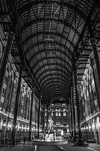 grayscale photo of statue under building thumbnail