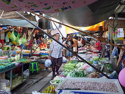 man holding plastic pack in marketplace thumbnail