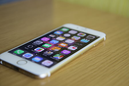 gold iPhone 6 on brown surface thumbnail