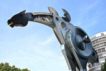 gray and black horse statue by day thumbnail