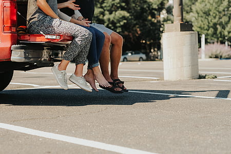 three person sitting on tail gate thumbnail