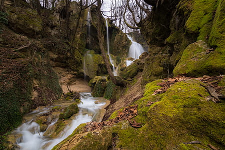 Long Exposure Photo of Stream Falling in Between Rocky Mountain thumbnail