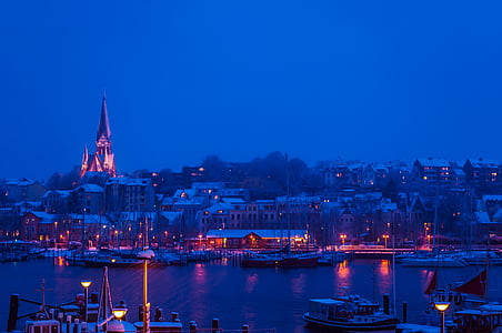skyline cityscape near body of water during nighttime thumbnail