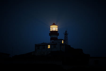 black lighthouse during night thumbnail