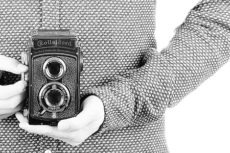 grayscale photo of person holding vintage camera thumbnail