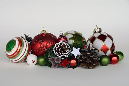 assorted-color baubles and pine cones on gray surface thumbnail
