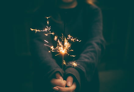 person holding lighted sparkler thumbnail