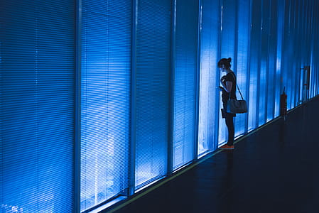 Woman Standing Near Blue Led Wall thumbnail