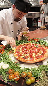 man putting toppings on pizza thumbnail