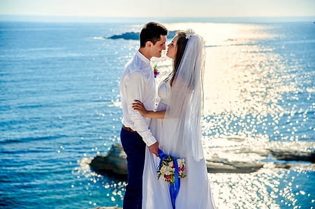 woman and man standing in front of ocean thumbnail