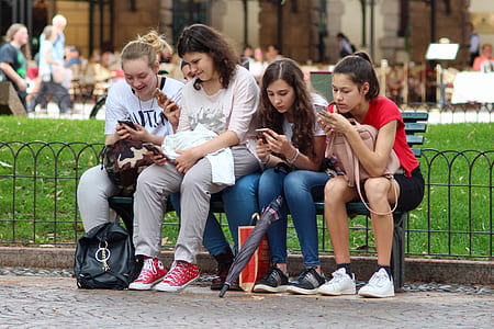 four woman sitting on bench thumbnail