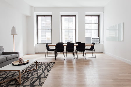 brown wooden table with black chairs thumbnail