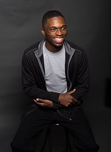 man in gray top and black zip-up jacket thumbnail