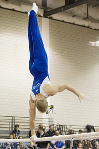 male balancing on pole thumbnail